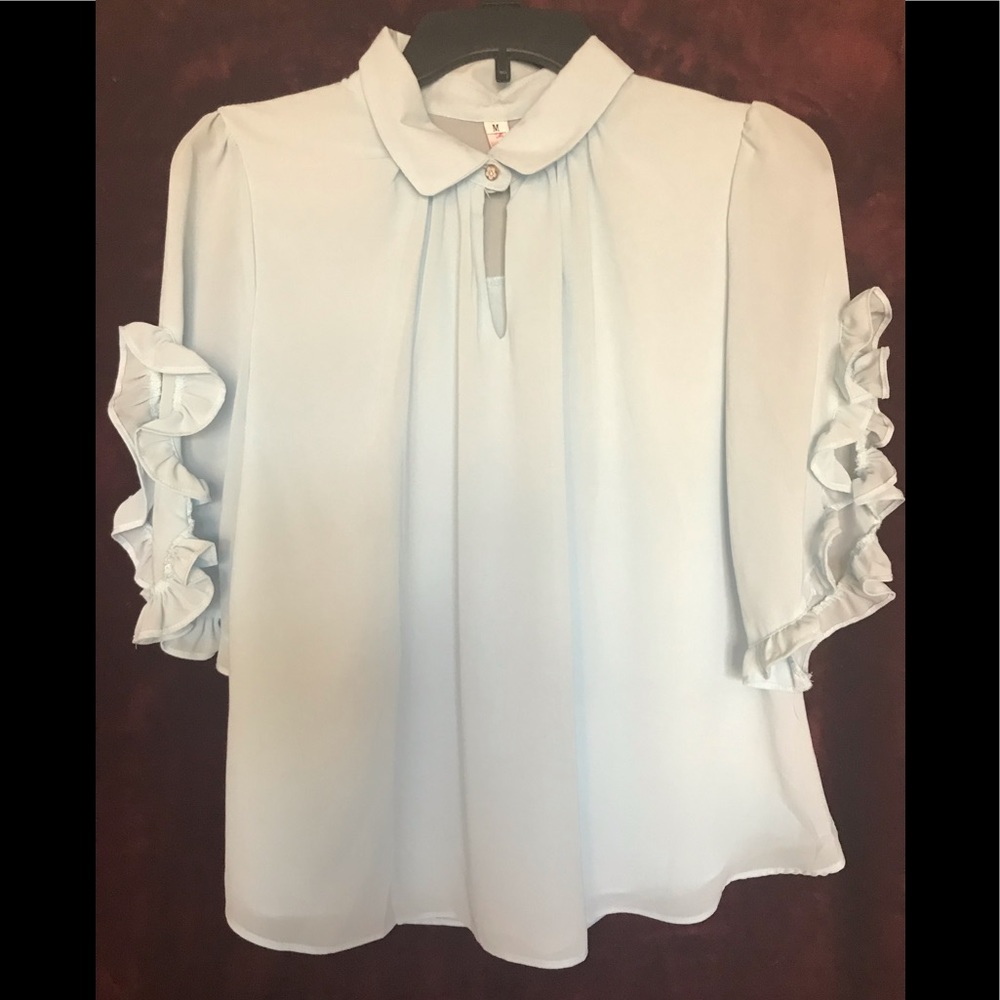 Airy, baby blue blouse offering tailored sleeves